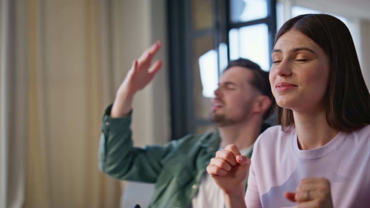 Emotional man cheering sport game at sofa closeup. Couple reacting nervously