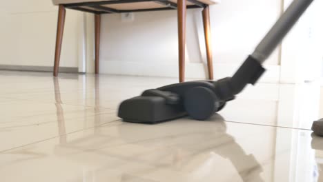 a vacuum cleaner cleaning a tile floor