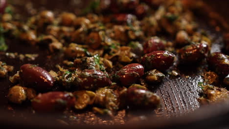 Close-up-shot-of-cooking-Italian-food-in-a-pan-with-a-wooden-spoon