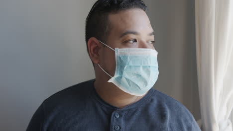 young hispanic male putting on a face mask