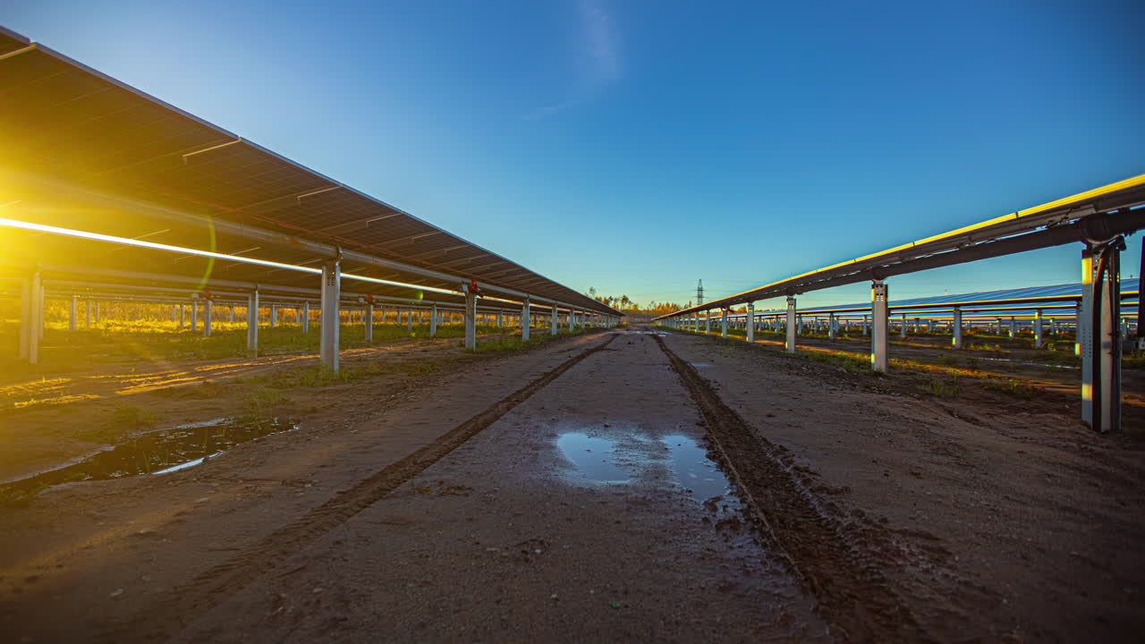 Time-lapse of contemporary photovoltaic panel system tracking the sun, sunset