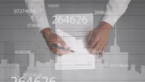 animation of diverse financial data and graphs over hands of caucasian businessman writing