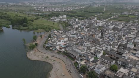 horizontal panning aerial footage showcasing the picturesque west coast of erhai lake in dali, yunnan province in china