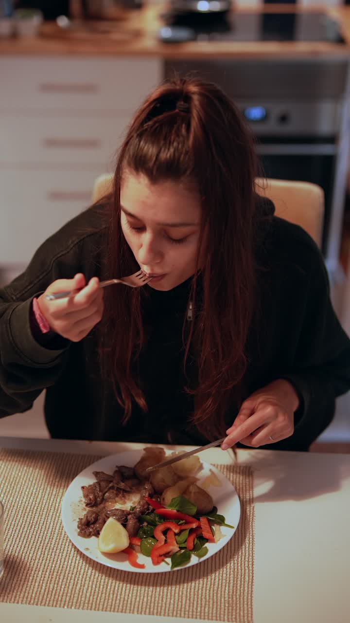 Woman Eating Steak Dinner at Home