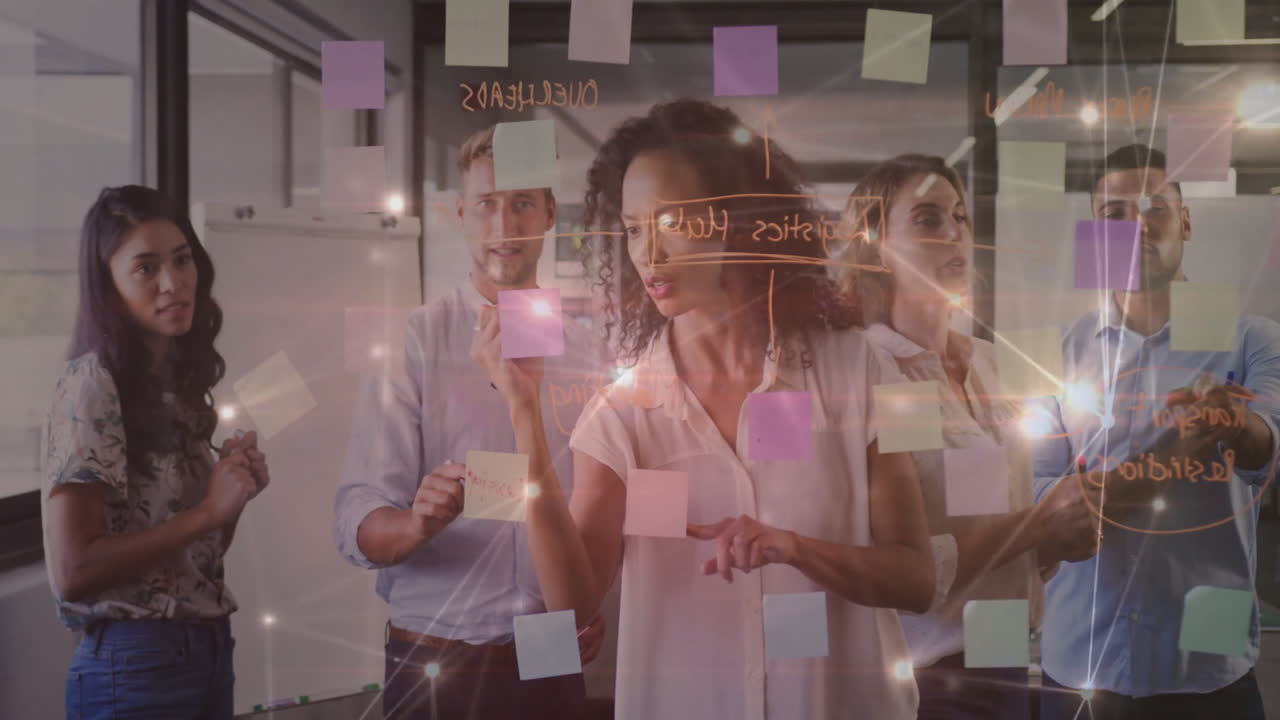 Brainstorming with sticky notes, diverse team creating animation in office