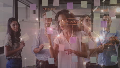 brainstorming with sticky notes, diverse team creating animation in office