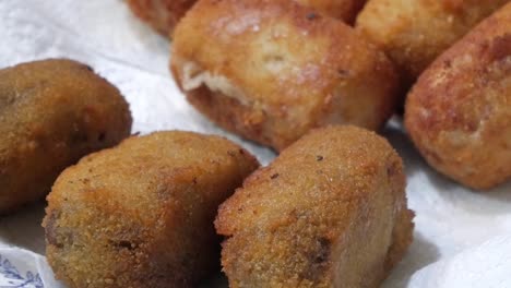 closeup plate with fried breaded croquettes