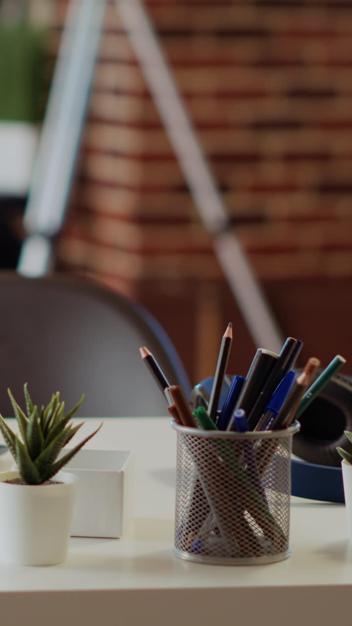 Vertical video Laptop on desk next to mini house plants in cozy stylish empty apartment