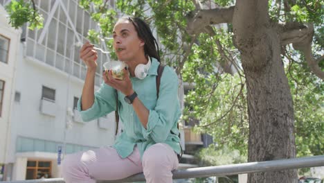 Mixed-race-man-eating-outside