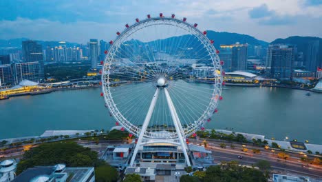 giant ferris wheel overlooking a city skyline at dusk