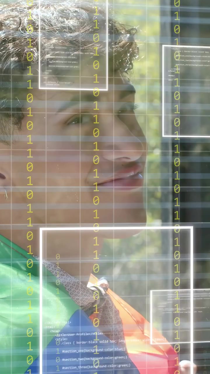 Vertical video: Adult man turning, smiling by glass, showcasing tech grid, binary UI masking face