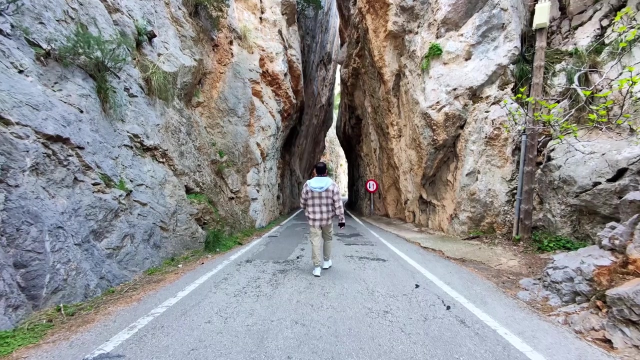 Drone Follow Shot of a Man Walking through Sa Calobra Gorge Pass in Mallorca