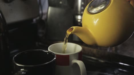 filling the cup with hot tea - close up shot