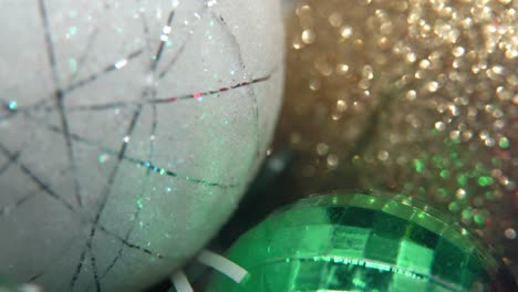 decoración de navidad, coloridos adornos de cristal bolas doradas, blancas y verdes, año nuevo decorado, luces brillantes, cinematográfico close-up macro inclinar hacia abajo video 4k, hermosa profundidad de campo, iluminación bokeh