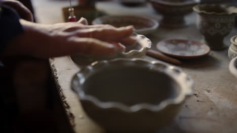 Woman-preparing-for-decorations-in-workshop.-Ceramist-checking-clay-preparedness