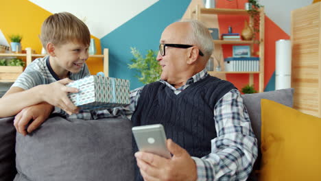 Grandson Giving Gift to Grandfather
