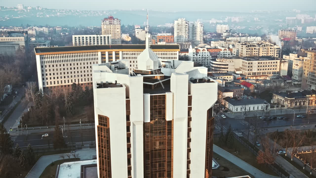 Aerial drone view of Chisinau downtown. View of Parliament and Presidency, roads with moving cars and bare trees. Sunny weather. Moldova