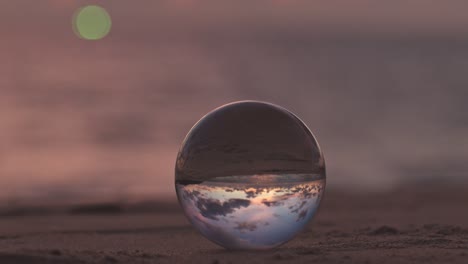 beautiful sunrise above the sea inside crystal ball.