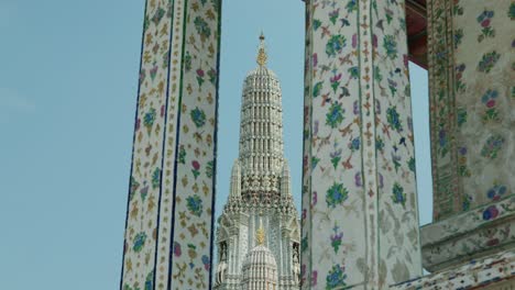 4K-Cinematic-religious-travel-scenic-footage-of-the-Buddhist-temple-of-Wat-Arun-in-the-old-town-of-Bangkok,-Thailand-on-a-sunny-day