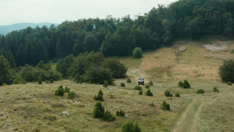 all terrain vehicle atv driving on mountainside dirt tracks, aerial view