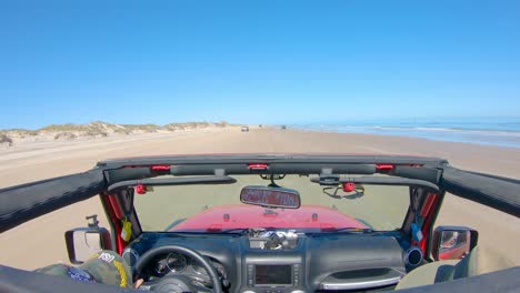 pov while driving past vacationers while on the beach, roof top removed from off road vehicle - south padre island, texas