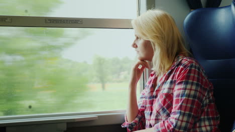 woman looking out of train window
