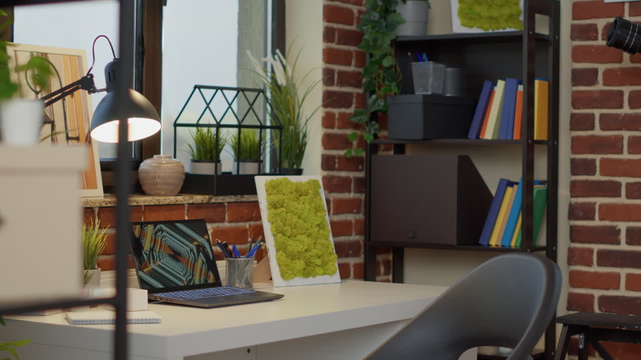 No people at empty desk with laptop computer in apartment