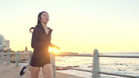 woman running on a coastal pier at sunrise