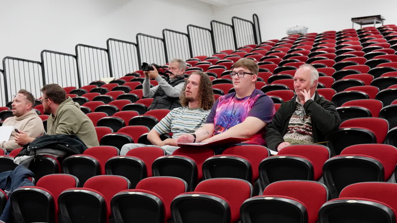 Indoor local media event, auditorium facilities, audience members