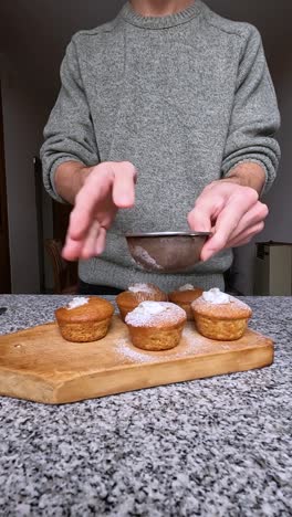 adding powdered sugar to decorate homemade cupcakes