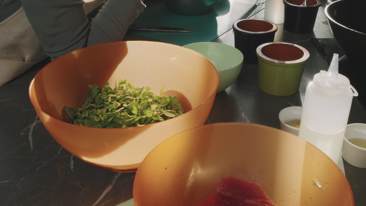 Bowl With Arugula On Cooking Table