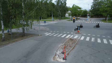 high angle view as bikers on custom motorcycles turn street corner