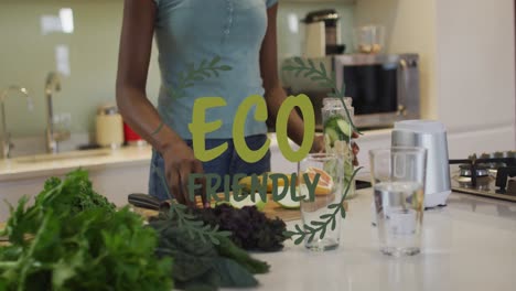 animación de texto ecológico y hojas sobre feliz mujer afroamericana cocinando