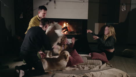 friends having a pillow fight by the fireplace