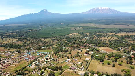 aerial drone view open air market in the loitokitok town, kenya and mount kilimanjaro- rural village of kenya