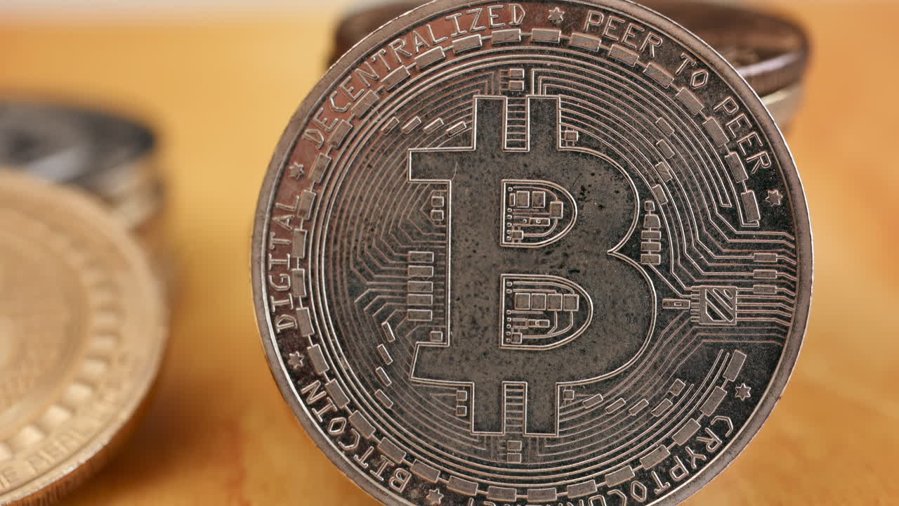 Close up of shiny physical Bitcoin coins stacked on a table