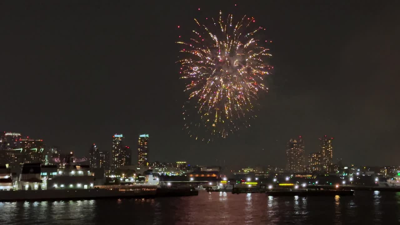 Bright fireworks illuminate the night sky above the Yokohama Port during the festival