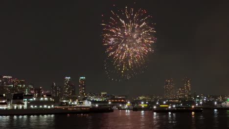 bright fireworks illuminate the night sky above the yokohama port during the festival