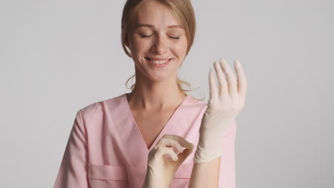 caucasian female doctor wearing medical gloves.