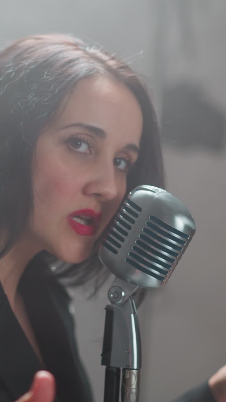 primer plano de una vocalista femenina apasionada con labios rojos cantando y chasquando los dedos, en un fondo borroso, enfatizando su intensa actuación