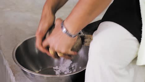 Preparing-a-fresh-Coconut-for-cooking-a-classic-Thai-Curry-in-Koh-Samui,-Thailand