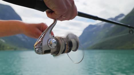 woman fishing on fishing rod spinning in norway.