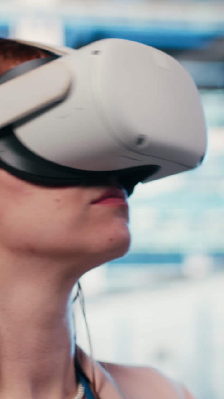 Vertical video Female technician in server room putting VR goggles on