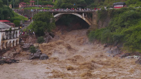 drone shot of huge flood disaster in kathmandu nepal where bagmati river causing alarming climate crisis and devastation to infrastructures, people come to rescue in river banks due to cloud brust