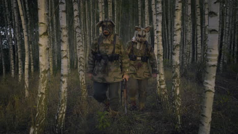 soldiers in pig and dog masks in a forest