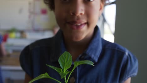 girl holding plant in the class