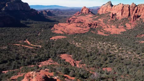 Sedona,-Arizona-USA,-Revealing-Drone-Shot-of-Landscape,-Red-Sandstone-Hills-and-Bush-Land