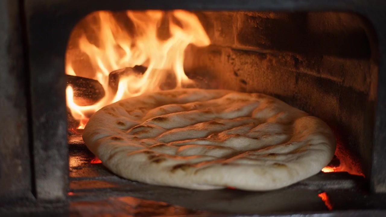 Flatbread Baking in a Traditional Wood-Fired Oven