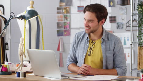 Male-Business-Owner-Working-In-Fashion-Sharing-Sales-Chart-On-Video-Call-Using-Laptop