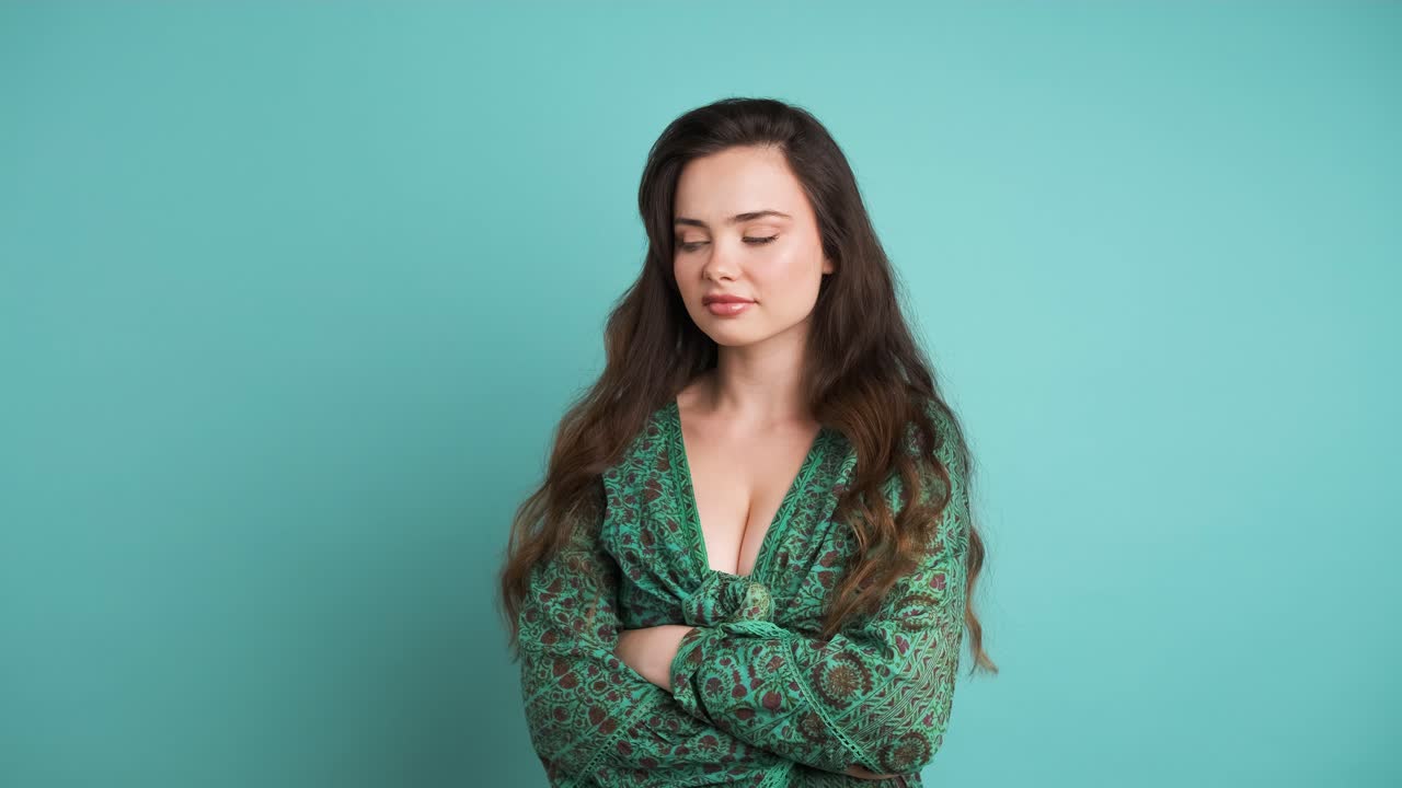 Woman with confused expression and making face in blue studio